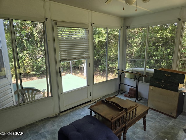 sunroom / solarium featuring ceiling fan