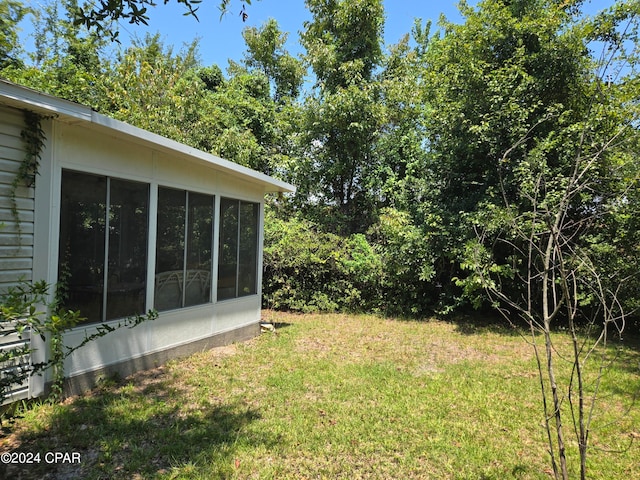 view of yard with a sunroom