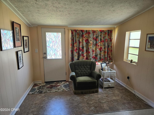 unfurnished room with a textured ceiling, wooden walls, and ornamental molding