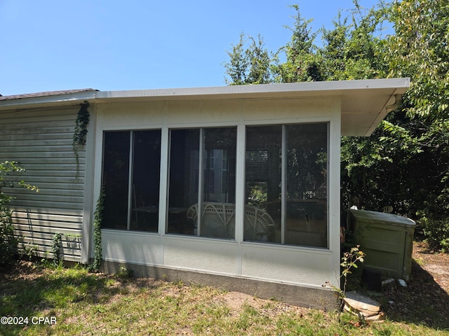 view of home's exterior with a sunroom