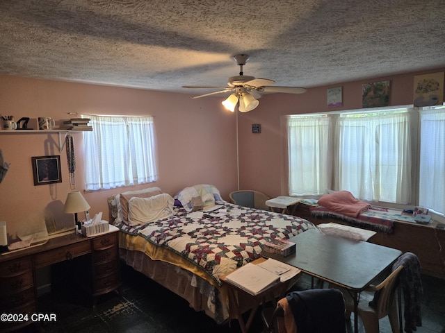 bedroom with a textured ceiling and ceiling fan