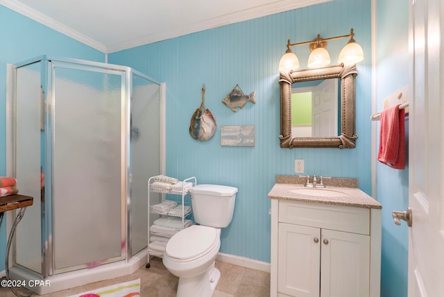 bathroom with a shower with door, toilet, vanity, tile patterned floors, and crown molding