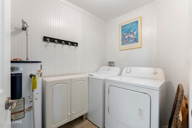 laundry area featuring crown molding, electric water heater, washing machine and clothes dryer, cabinets, and light tile patterned flooring