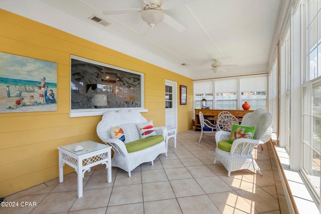 sunroom featuring ceiling fan