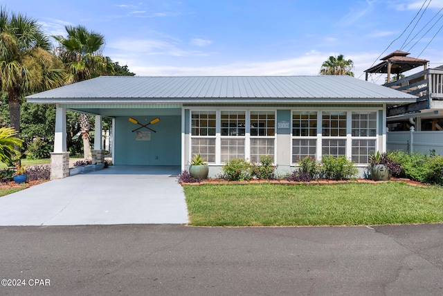 view of front facade with a carport and a front yard