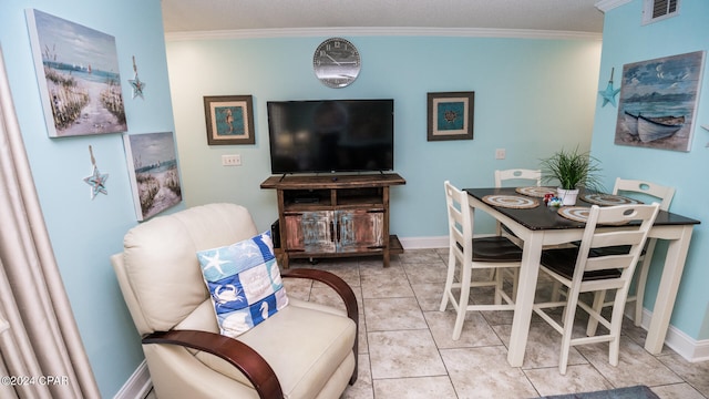 tiled dining room featuring crown molding