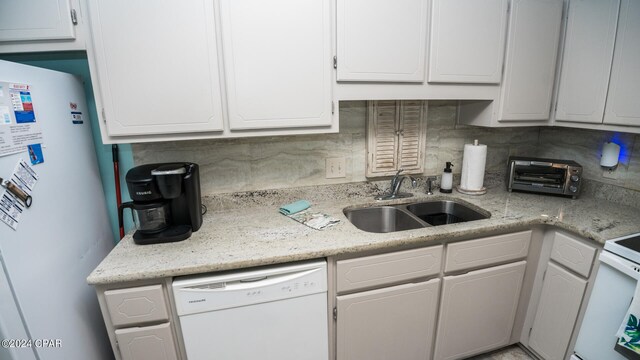 kitchen featuring white appliances, tasteful backsplash, white cabinetry, and sink