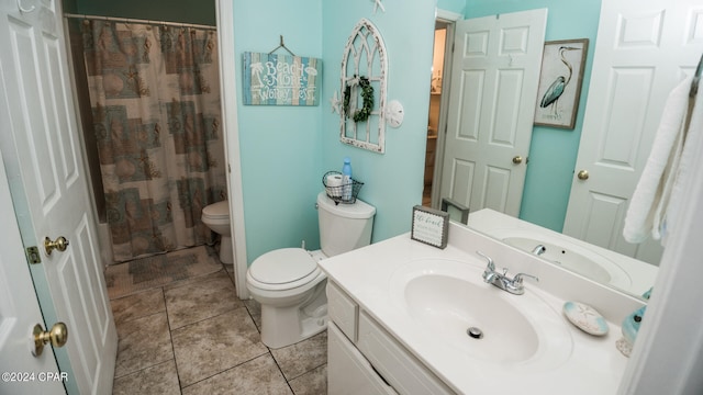 bathroom featuring a shower with shower curtain, vanity, toilet, and tile patterned floors