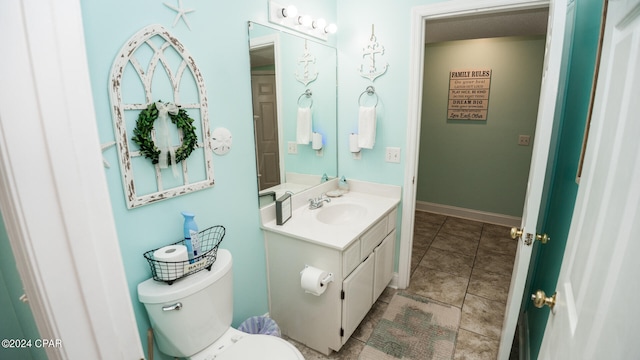 bathroom with vanity, toilet, and tile patterned flooring