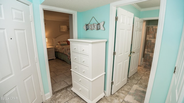 interior space featuring a textured ceiling and ornamental molding