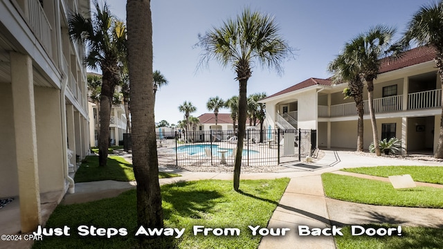 view of pool with a yard