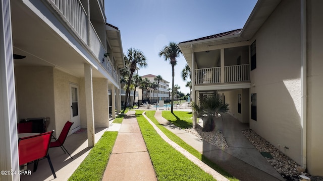 view of yard featuring a balcony and a patio