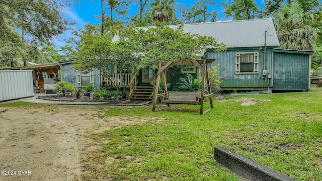 rear view of property with a lawn