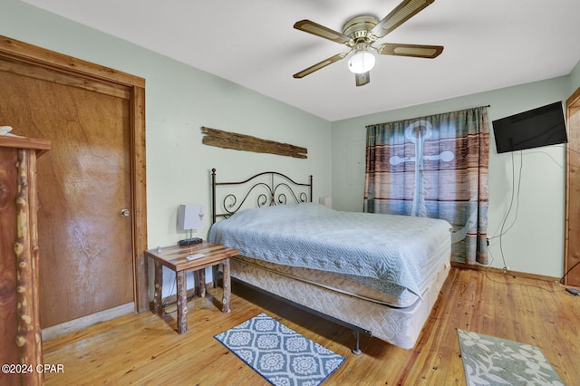 bedroom with ceiling fan and light hardwood / wood-style floors