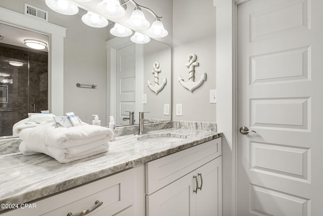 bathroom featuring vanity and a shower with shower door