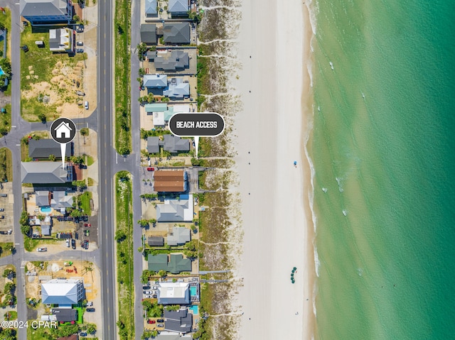 birds eye view of property featuring a beach view and a water view