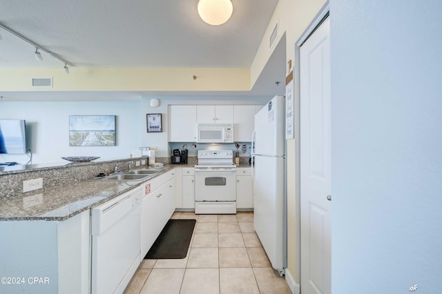 kitchen with white appliances, visible vents, a sink, and light tile patterned floors
