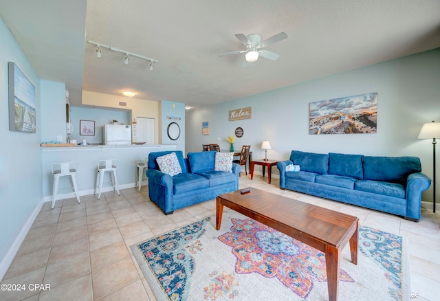 living room with light tile patterned floors, ceiling fan, and rail lighting