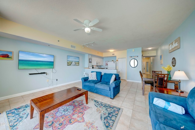 tiled living room featuring ceiling fan and track lighting