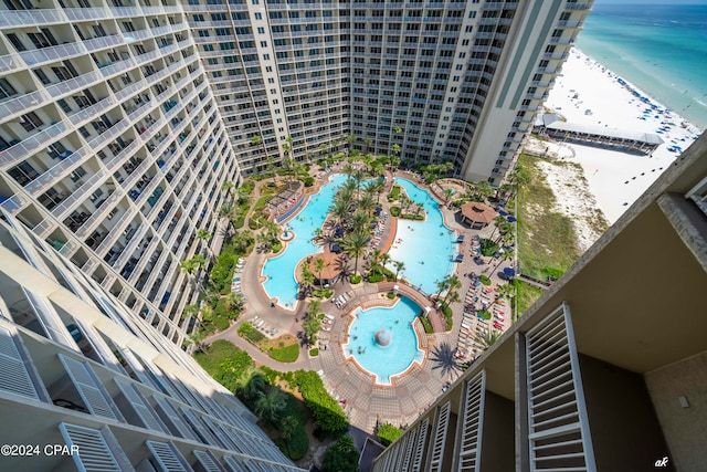 birds eye view of property with a water view and a view of the beach