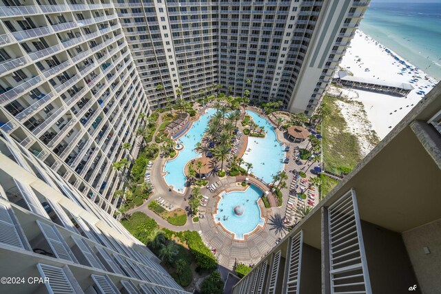 birds eye view of property featuring a water view and a beach view