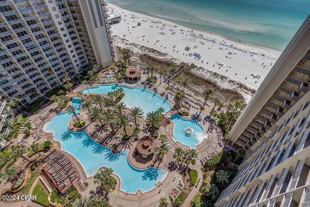 drone / aerial view featuring a water view and a view of the beach