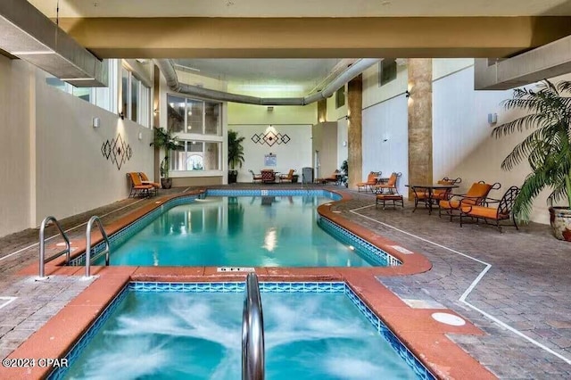 community pool with an indoor hot tub
