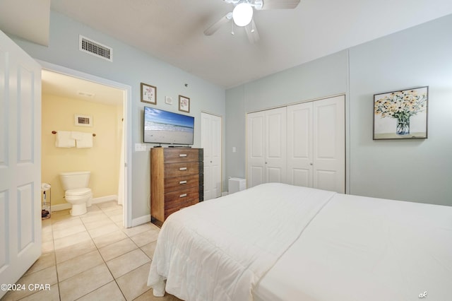 bedroom with light tile patterned floors, ensuite bath, a ceiling fan, visible vents, and baseboards