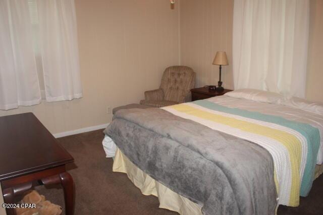 bedroom with dark colored carpet