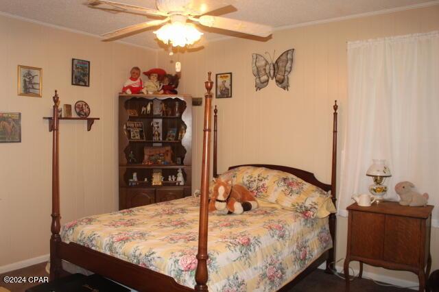 bedroom featuring ceiling fan and ornamental molding