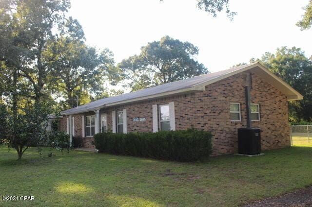 view of property exterior featuring a yard and central air condition unit