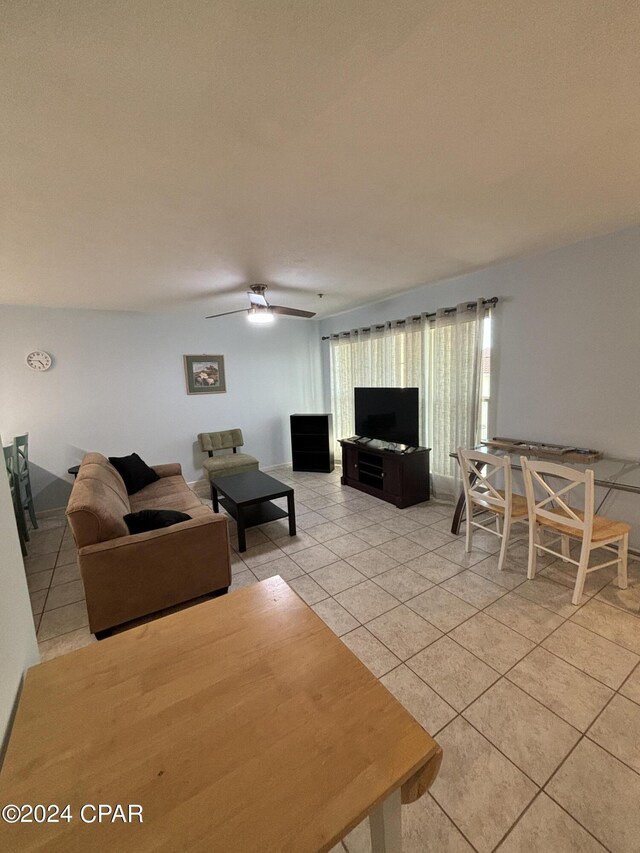 tiled living room with ceiling fan