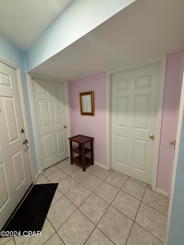 foyer entrance featuring light tile patterned floors