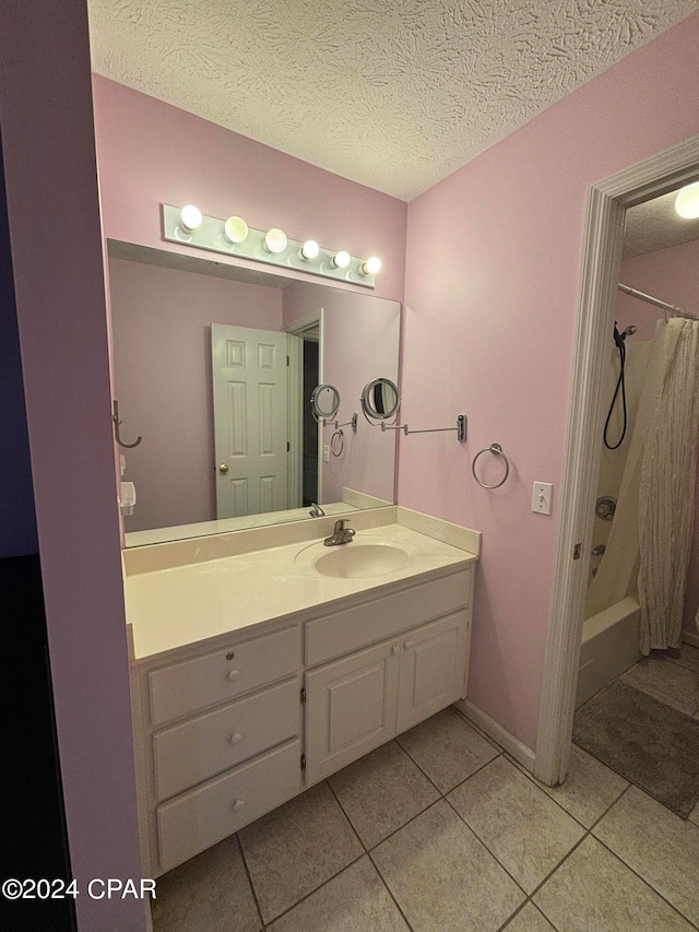 bathroom with shower / tub combo, tile patterned flooring, a textured ceiling, and vanity