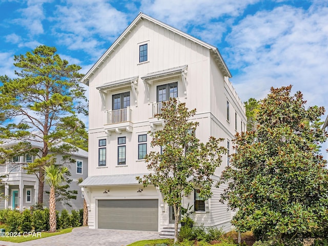 view of front of home with a garage and a balcony