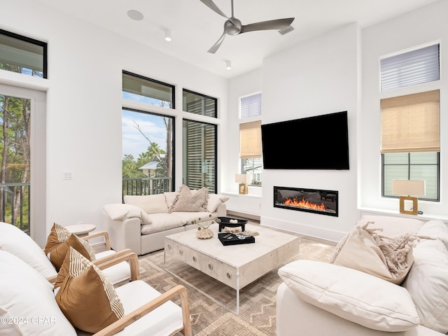 living room featuring a wealth of natural light and ceiling fan