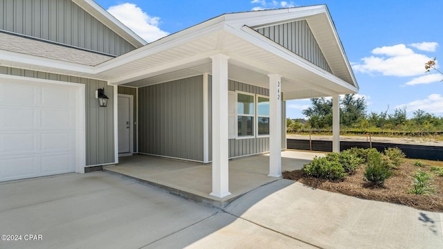 view of exterior entry featuring covered porch