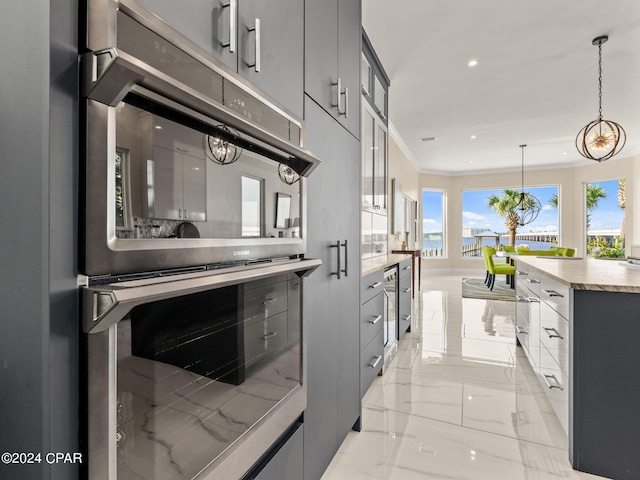 kitchen featuring modern cabinets, glass insert cabinets, ornamental molding, hanging light fixtures, and marble finish floor