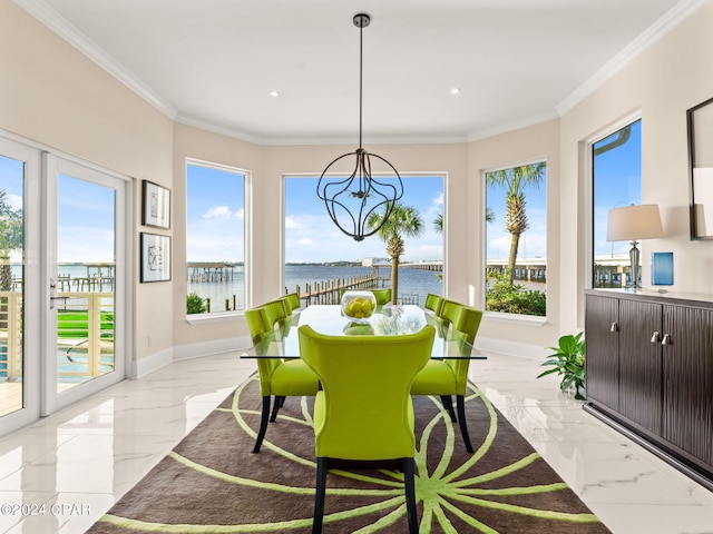 tiled dining space with a wealth of natural light, crown molding, an inviting chandelier, and a water view