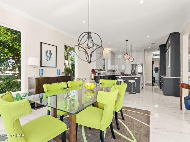 tiled dining area with crown molding and an inviting chandelier