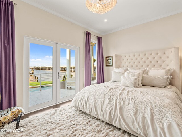 bedroom featuring hardwood / wood-style flooring, access to exterior, and ornamental molding