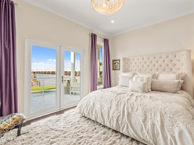 bedroom with a water view, wood finished floors, access to outside, french doors, and crown molding