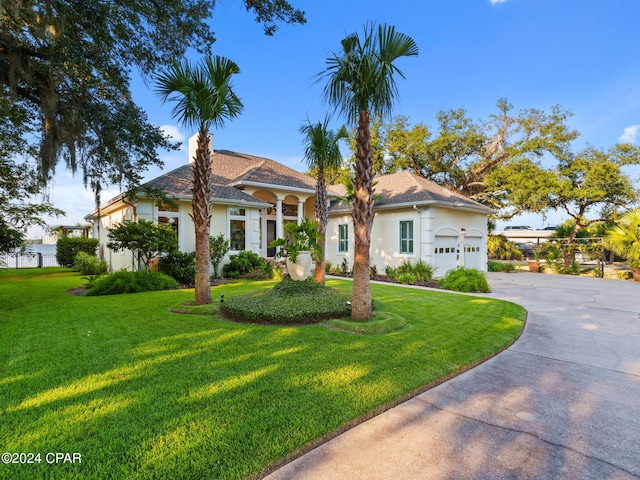 view of front of house featuring a garage and a front lawn