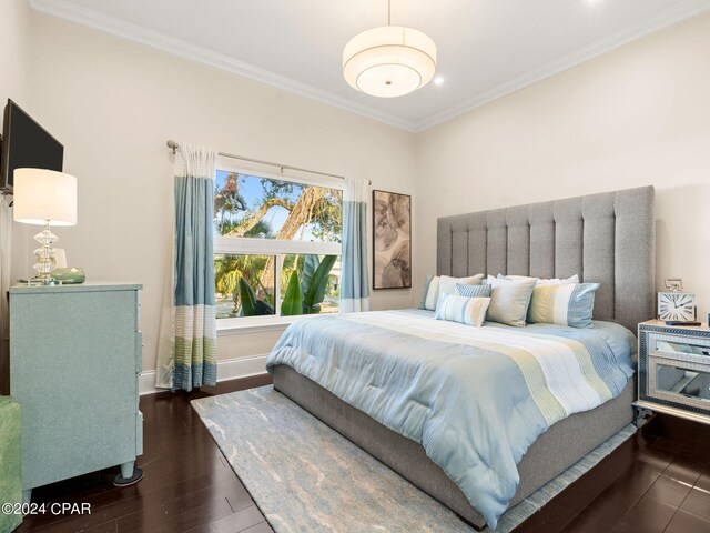 bedroom featuring dark hardwood / wood-style flooring and crown molding