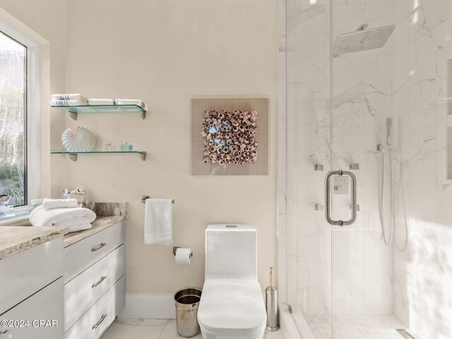 bathroom with tile patterned floors, a shower with shower door, vanity, and toilet