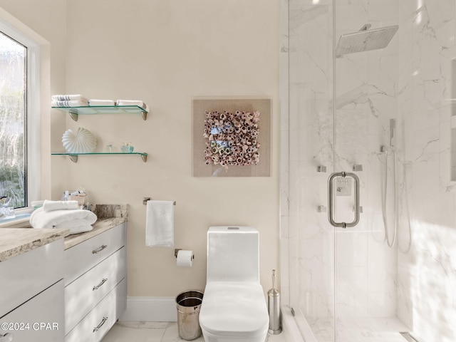 bathroom with marble finish floor, a marble finish shower, toilet, vanity, and baseboards