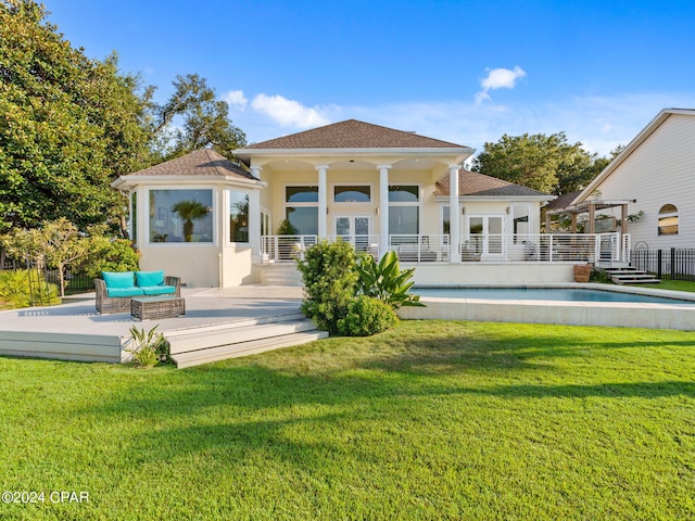 rear view of house with a yard, a wooden deck, an outdoor living space, and stucco siding