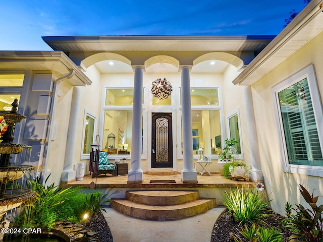 property entrance featuring stucco siding