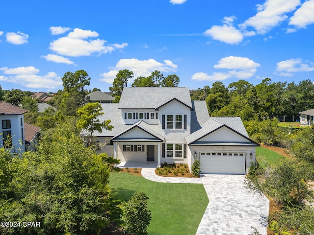 view of front of home with a front yard and a garage