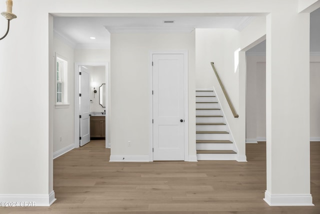 interior space featuring wood-type flooring and crown molding